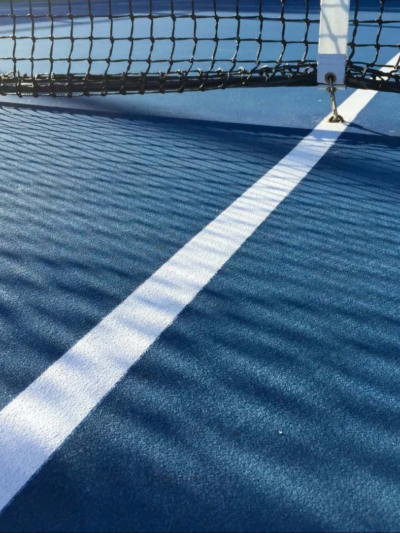 Blue tennis cort with net and net shadow Blue tennis cort with net and net shadow