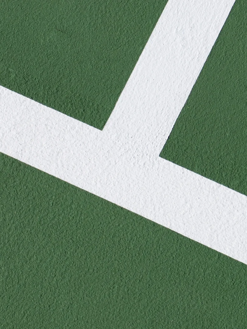 Green tennis court white lines crossing Green tennis court white lines crossing